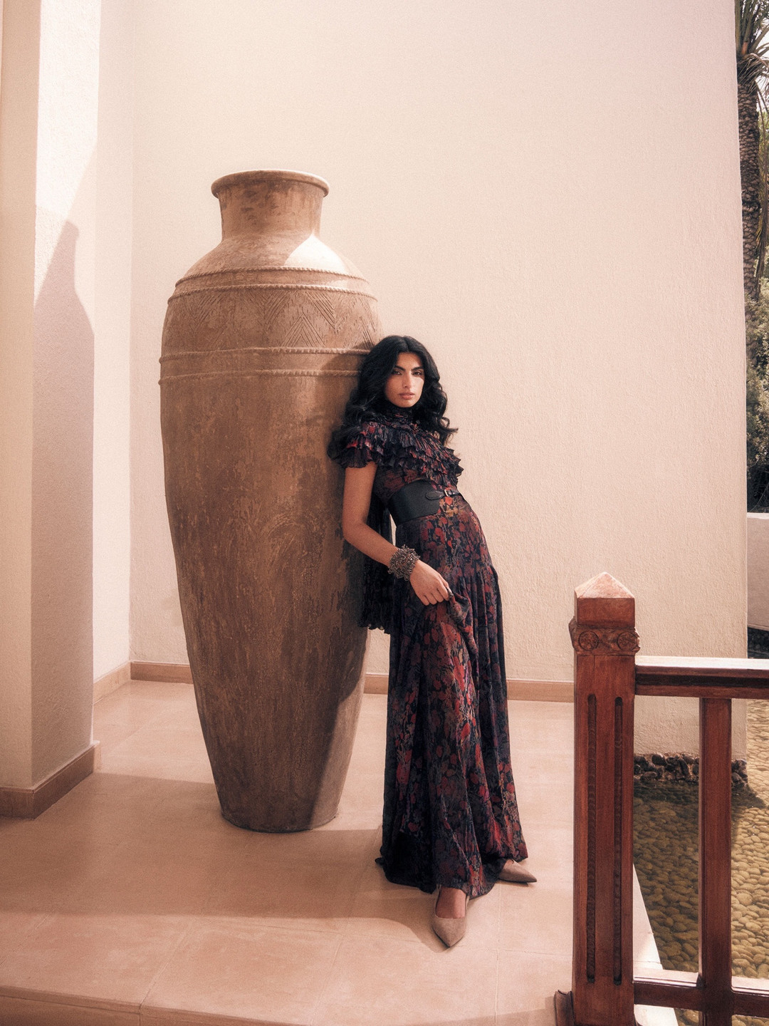 Fashion editorial of an ANT model beside terracotta pottery